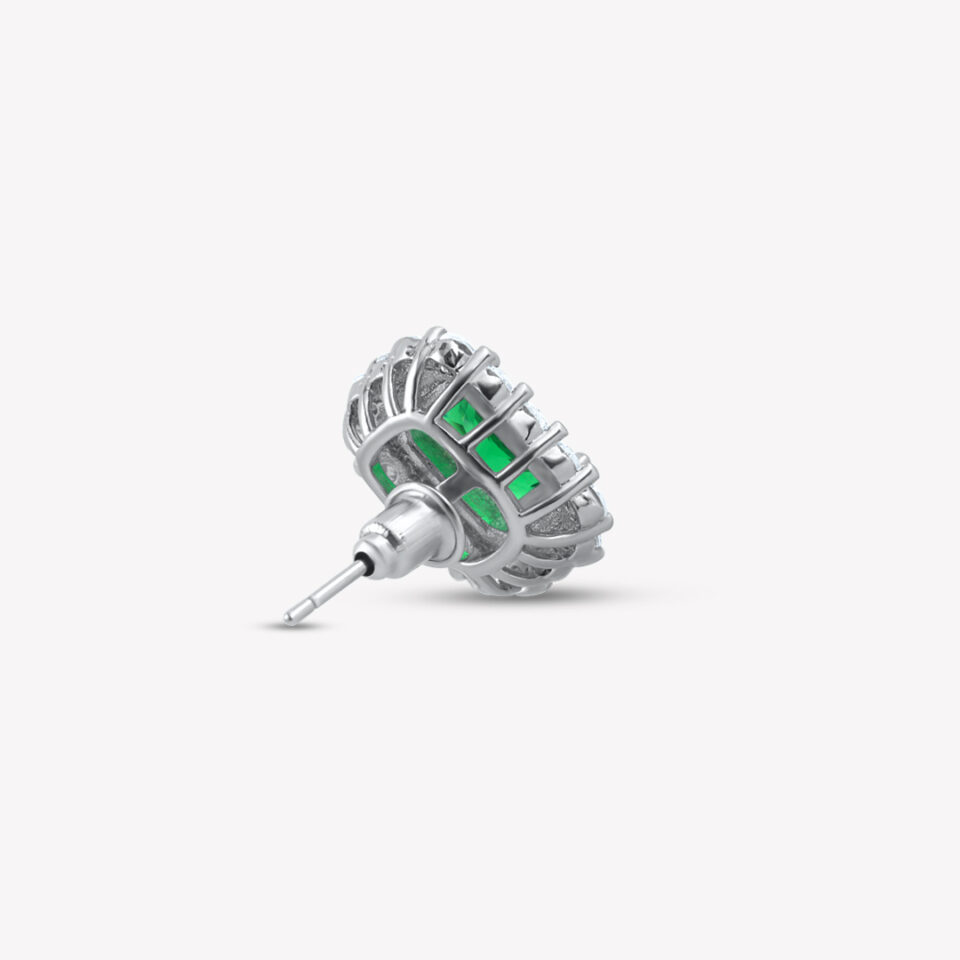 An emerald-cut green stud earring with a double halo of sparkling clear stones on a white background.